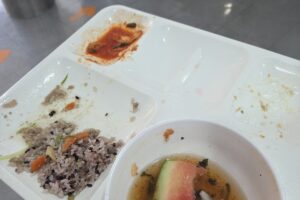 식사 뒤 밥알 몇 개와 수박 껍질만 남은 식판